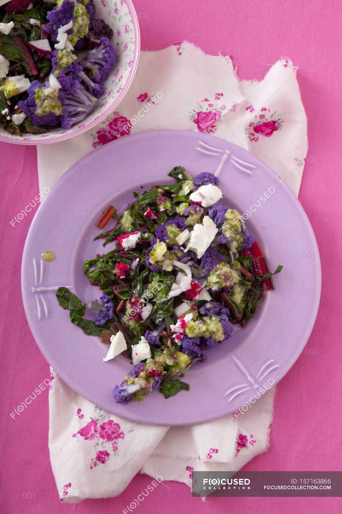 fish-and-chips-with-flower-salad-feta-closeup-stock-photo-157163866