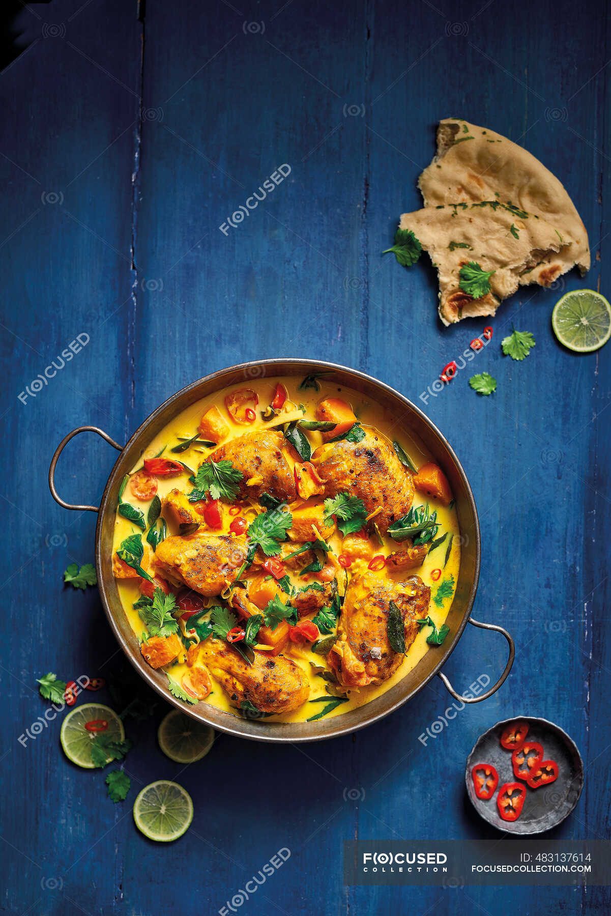Keralan Style Roast Chicken Curry served with naan bread and topped