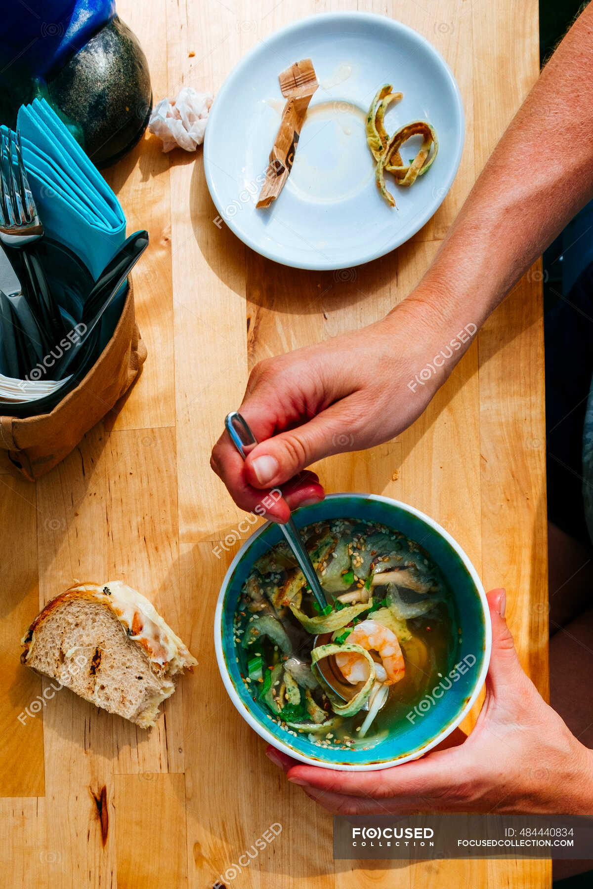 A cup of noodles soup at a table in a restaurant — food, product