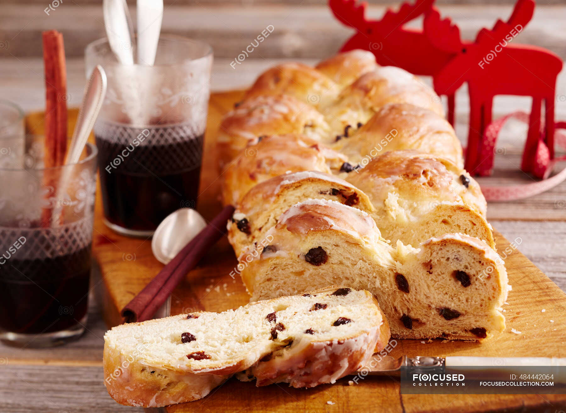 Raisin bread plait with icing — foodstuff, confectionery Stock Photo