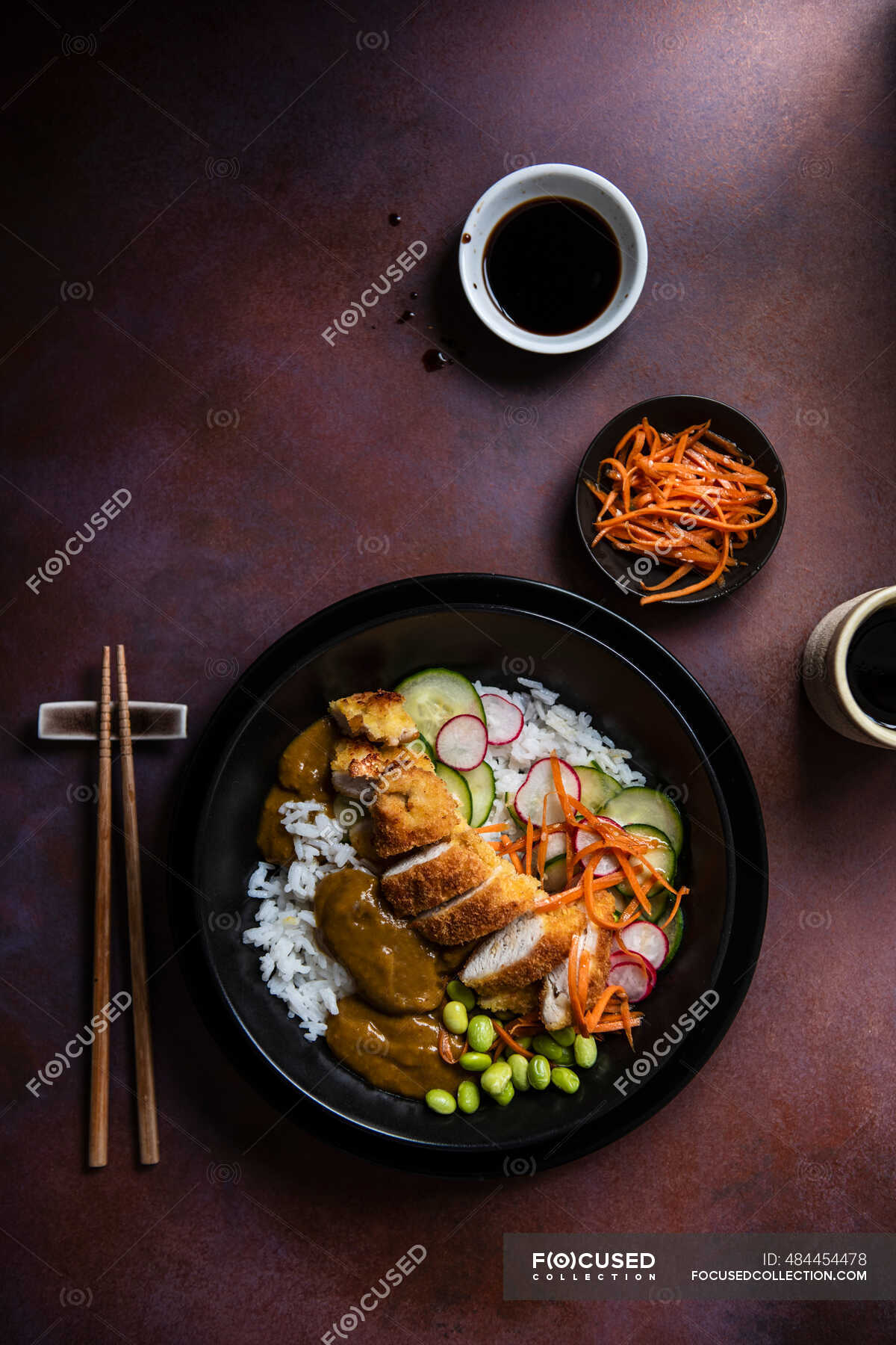 Japanese katsu chicken with pickled cucumber, carrots in seasame oil