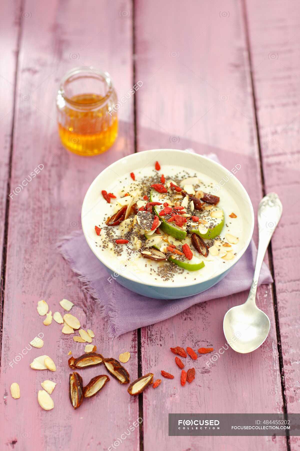 Almond milk soup with pear, almond flakes, goji berries and dates