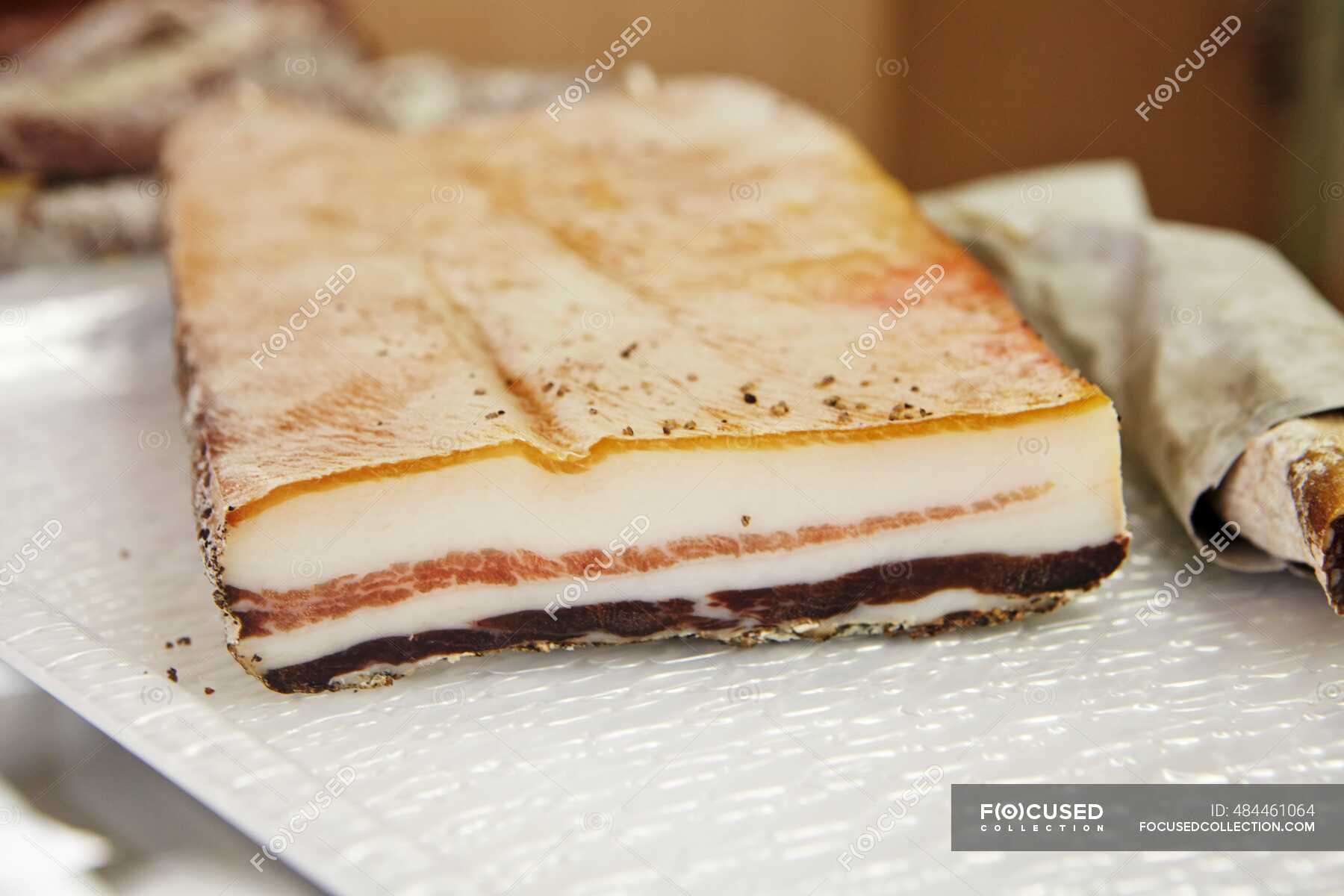 Pancetta on a meat counter — calorie, nutrient Stock Photo 484461064