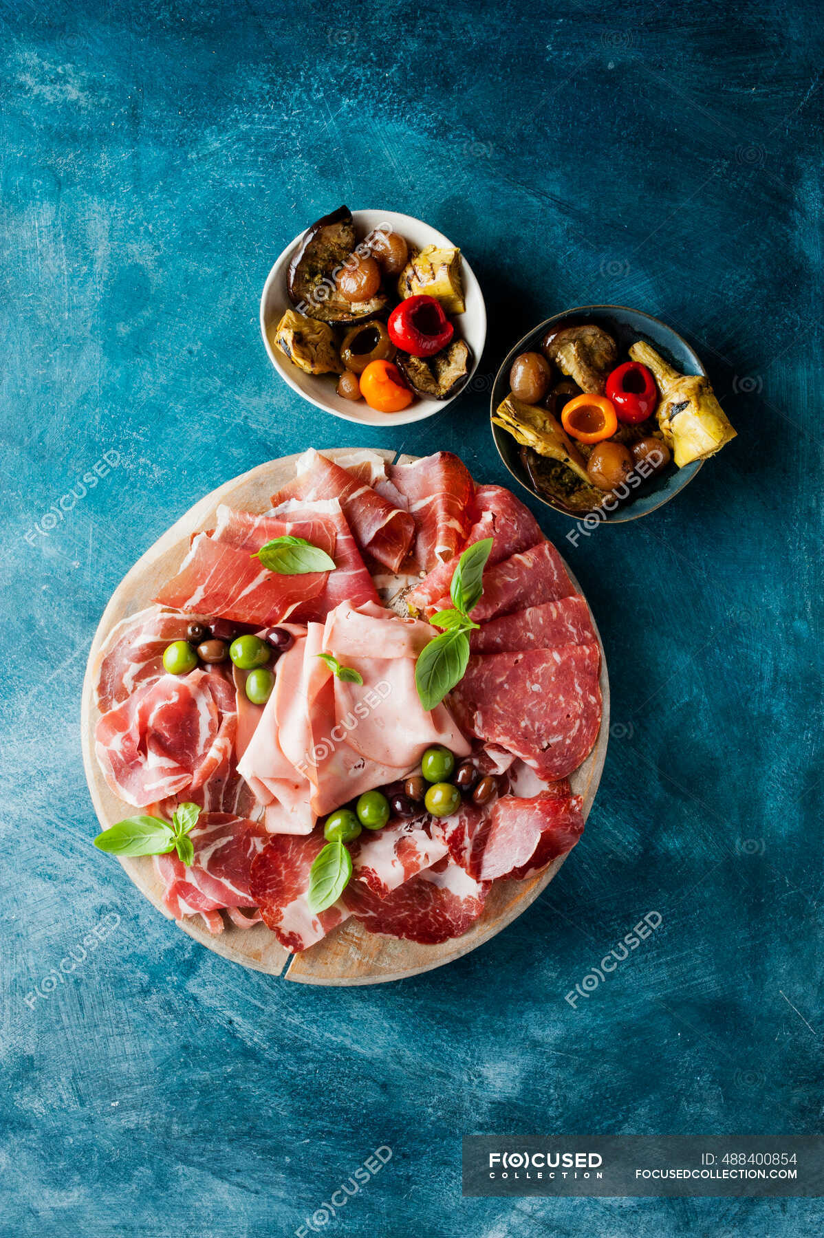 Prosciutto sandwich with ham, salami, cheese and olives. top view