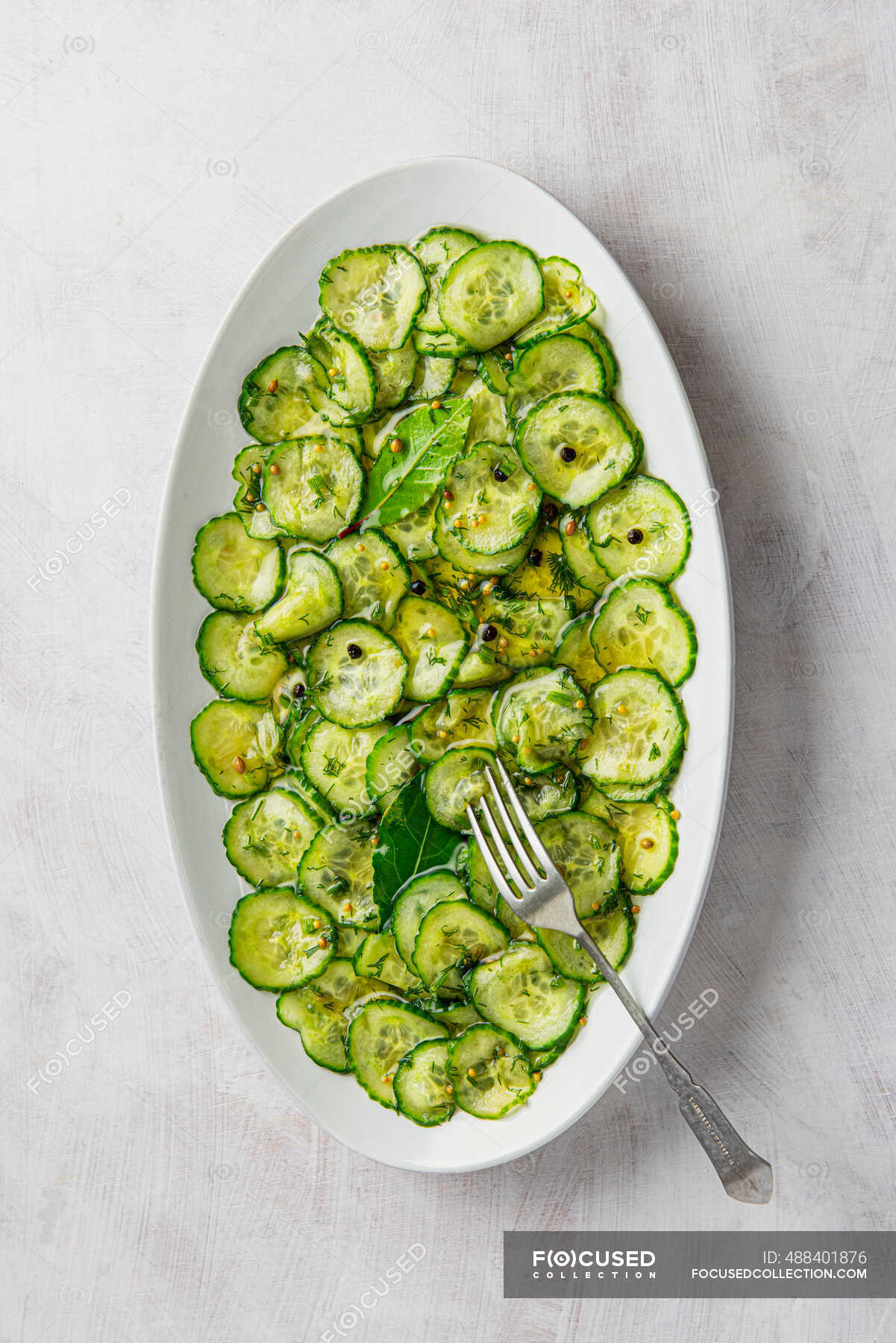 Quick sweet vinegar pickle sliced cucumber salad with dill, peppercorn