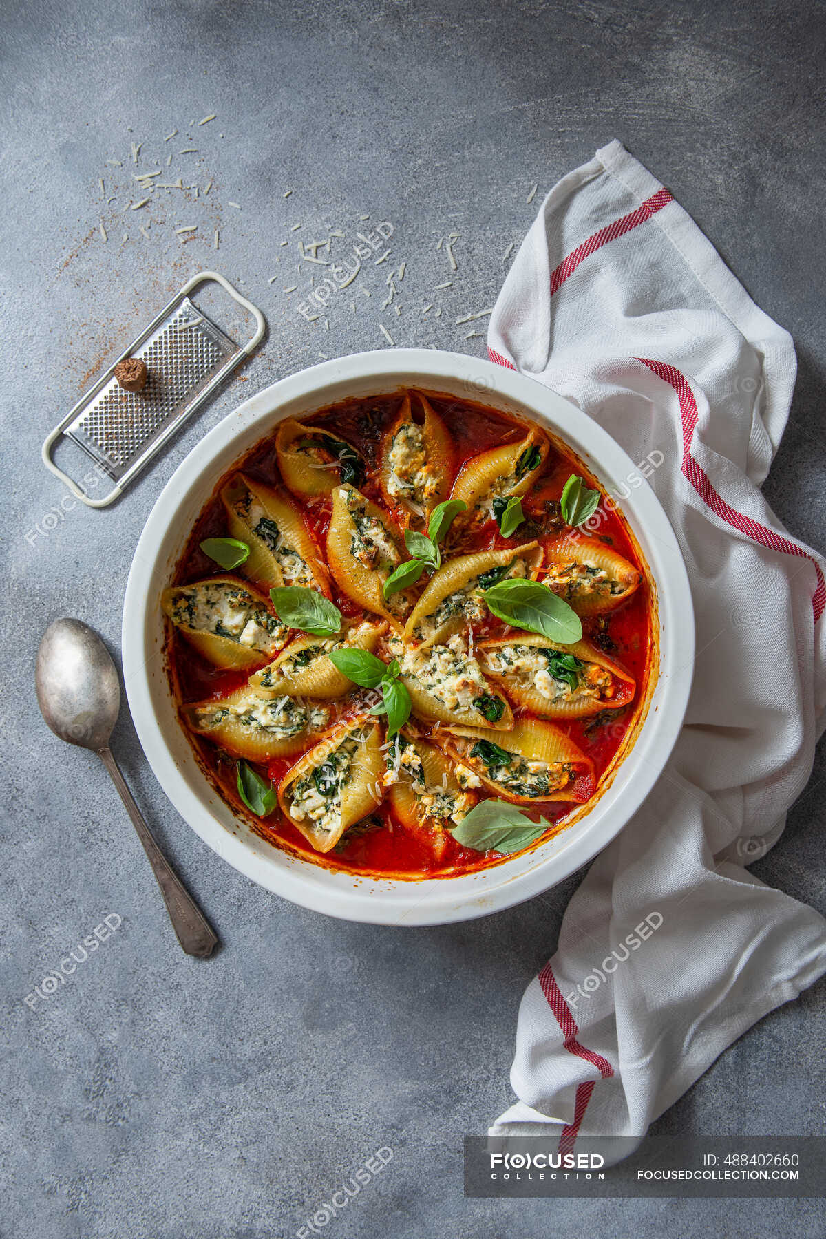 Conchiglioni pasta filled with ricotta cheese, nutmeg and spinach with tomato and basill sauce