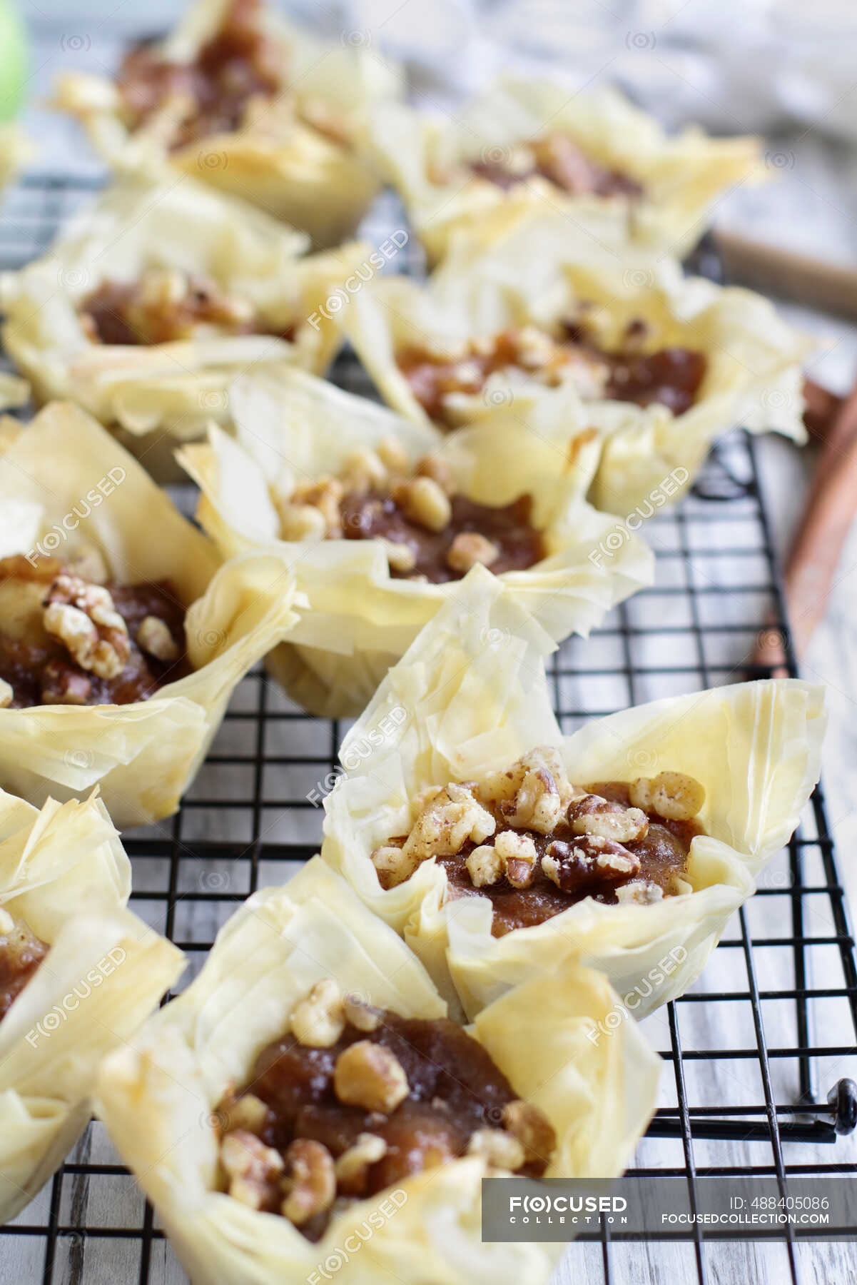 mini-apple-pies-with-phyllo-crust-cooling-on-a-bakers-rack-minicake