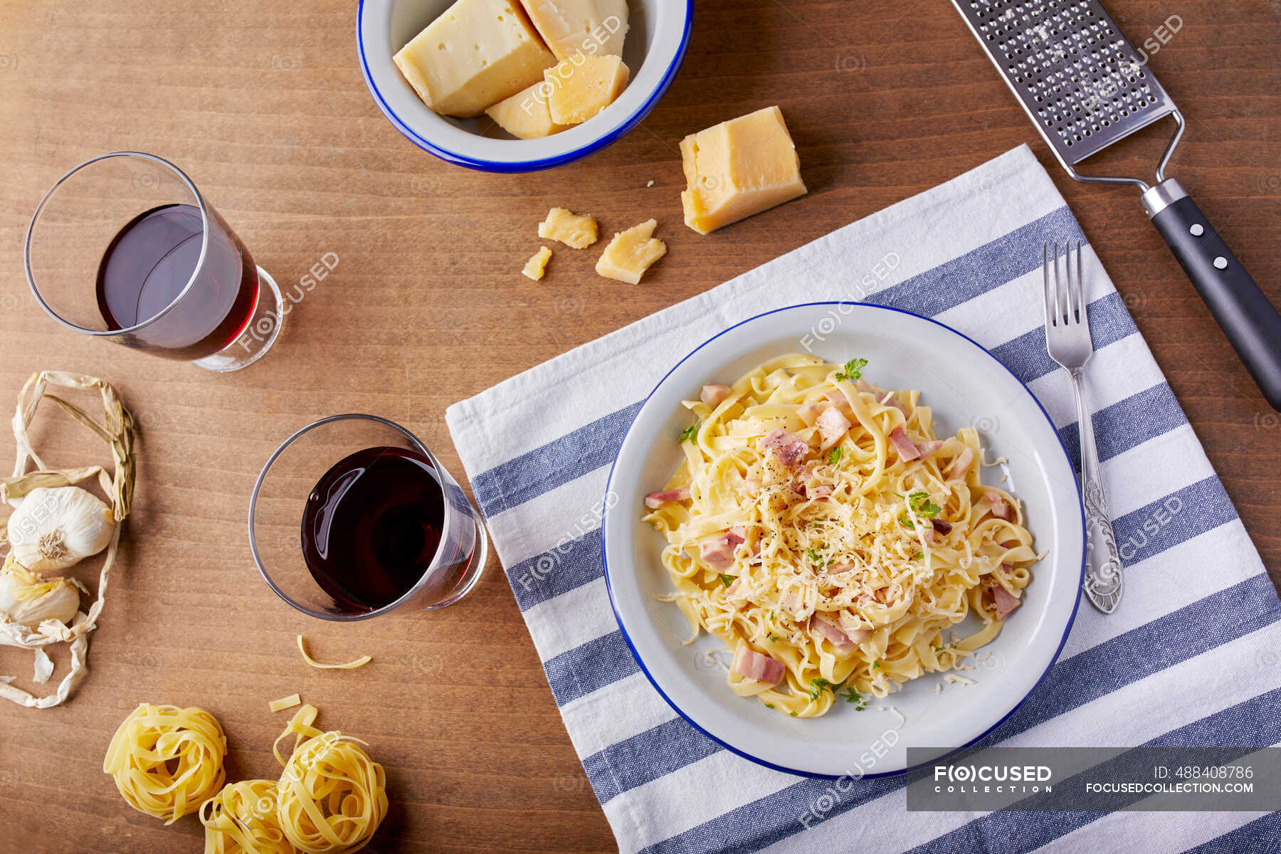 Homemade pasta Carbonara with parmesan cheese and glasses of red wine —  delicious, view - Stock Photo | #488408786