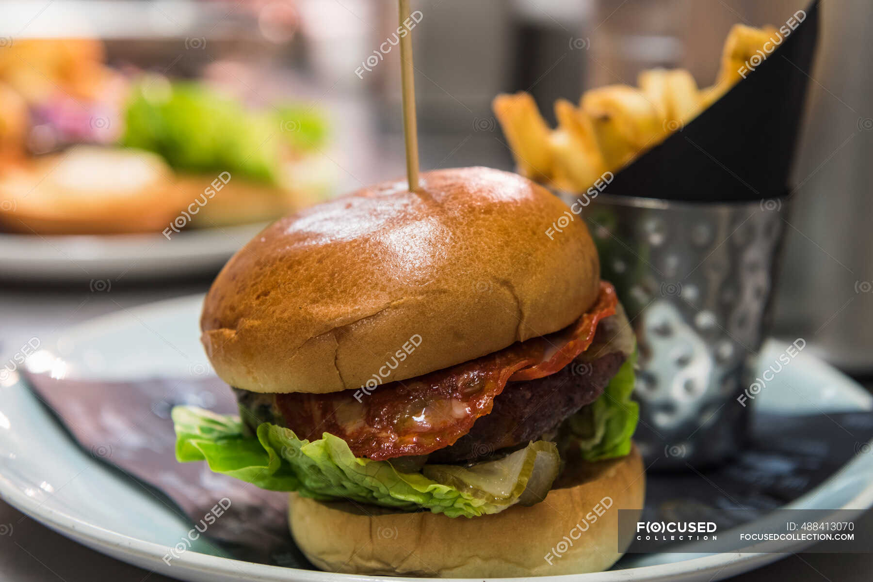 A bacon burger with chips — selling, cooked - Stock Photo | #488413070