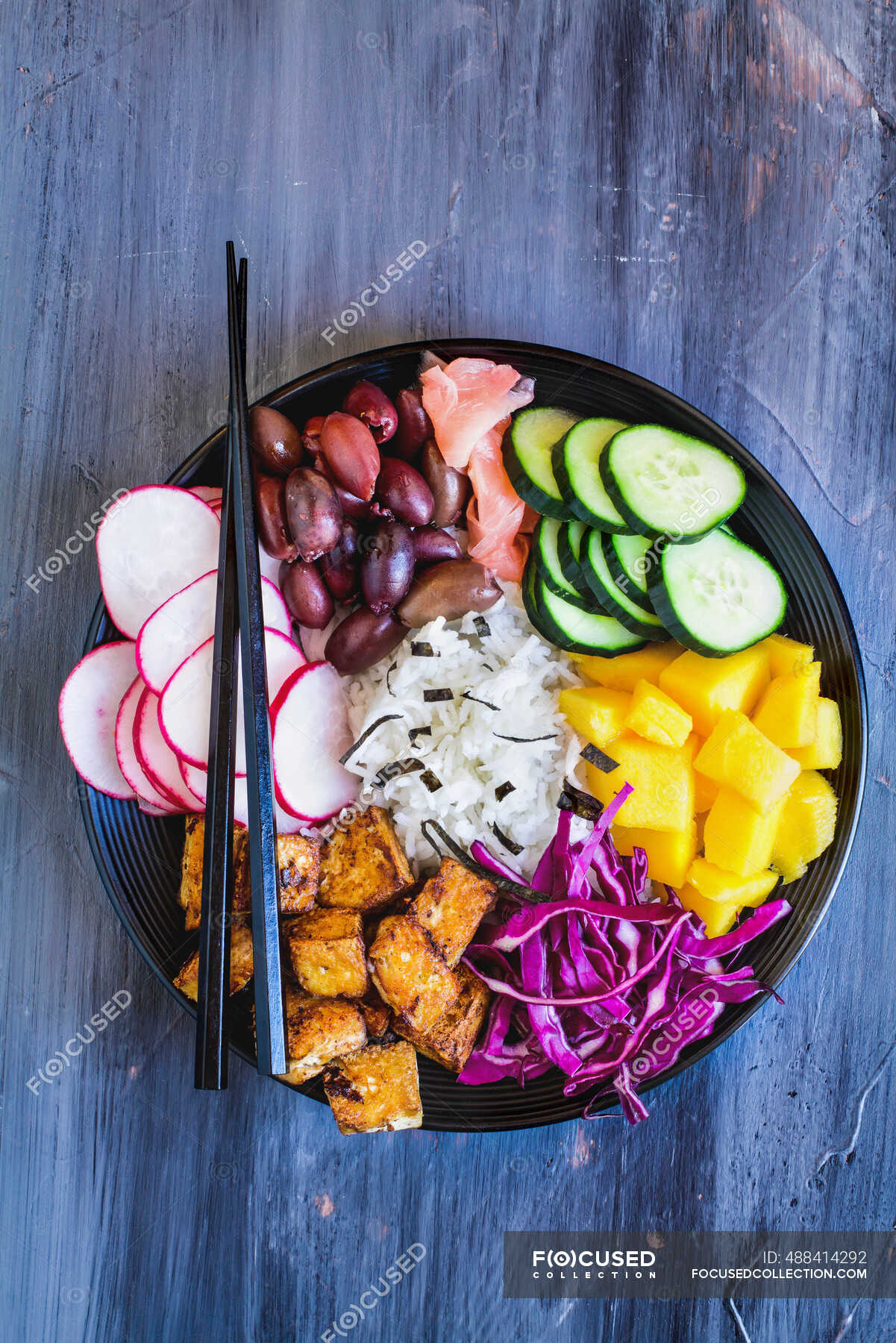 Buddha bowl with basmati rice, mango, fried tofu, purple cabbage