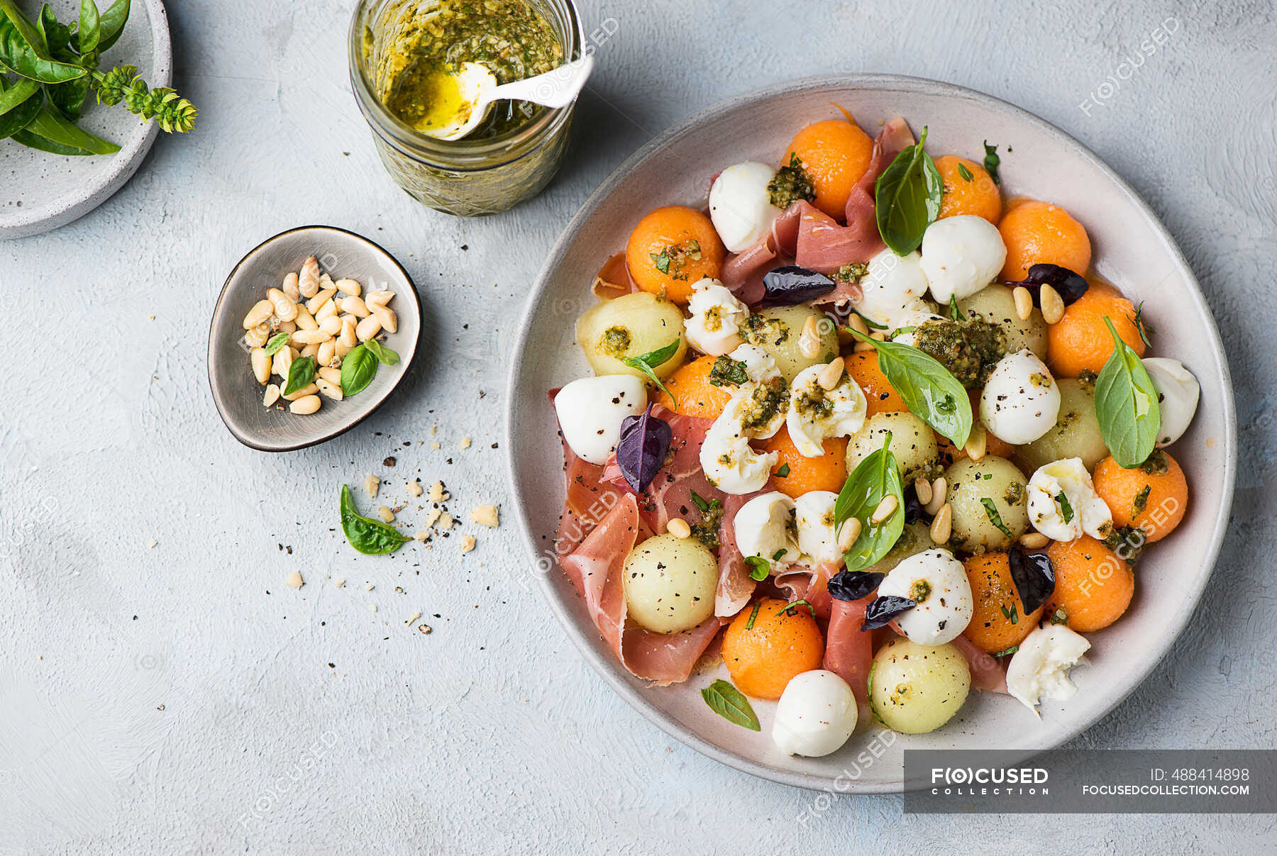 Melon with prosciutto, mozzarella, and pesto salad — surface, ripe