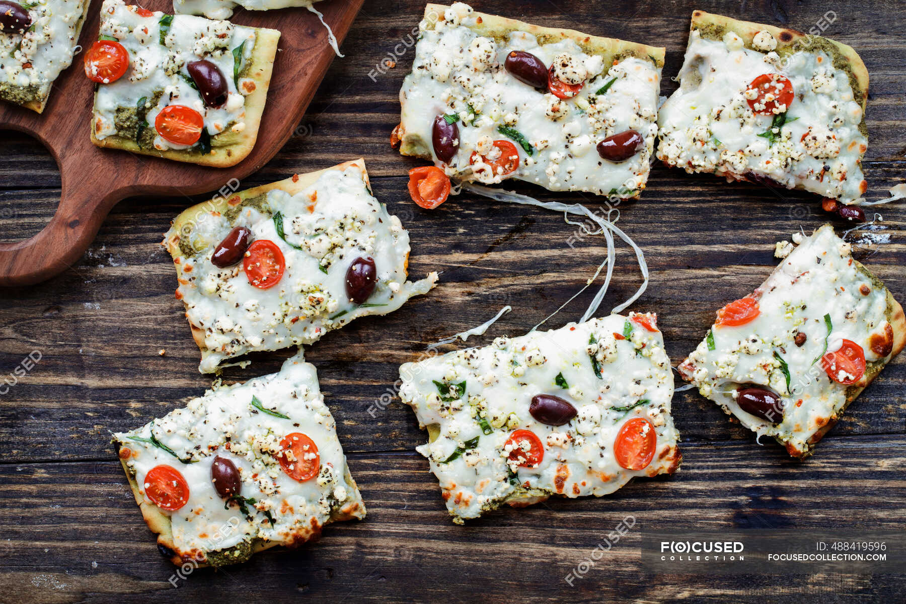 Artisan pizza with mozzarella cheese, fresh tomatoes, goats cheese