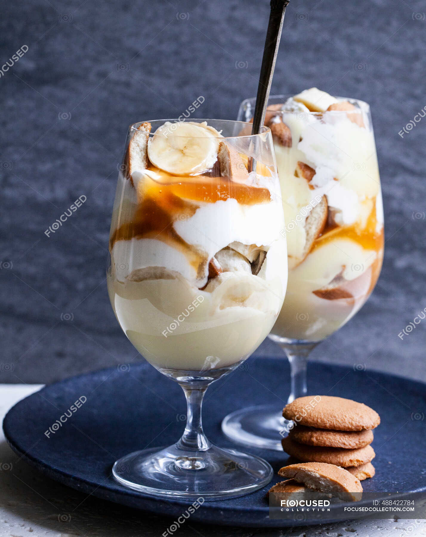 Glasses with banana pudding, sliced bananas, wafer cookies, vanilla ...