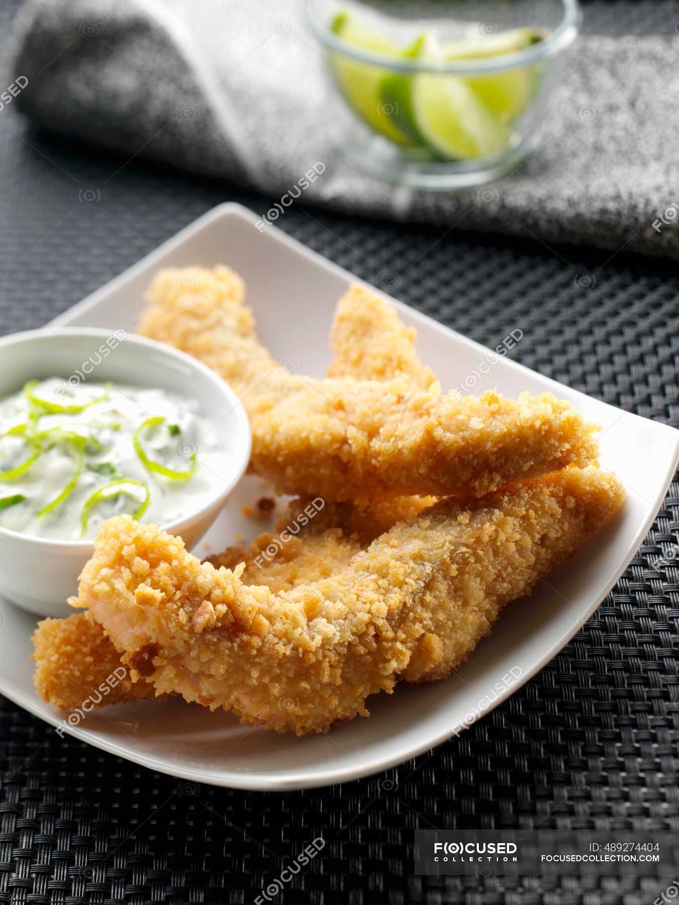 A plate of salmon goujons with dipping sauce — recipe, table - Stock ...