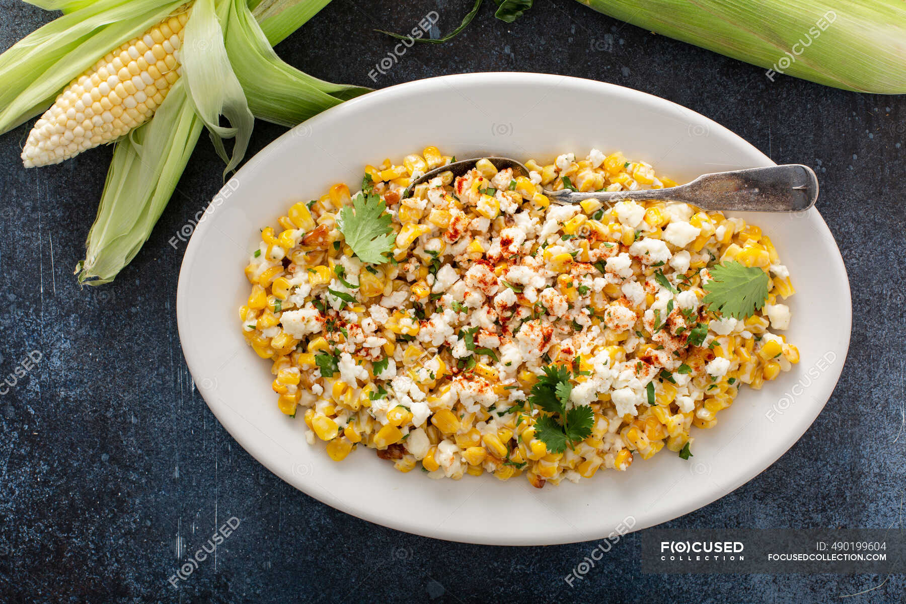 Mexican street corn, elote with cotija cheese, fresh cilantro and chili