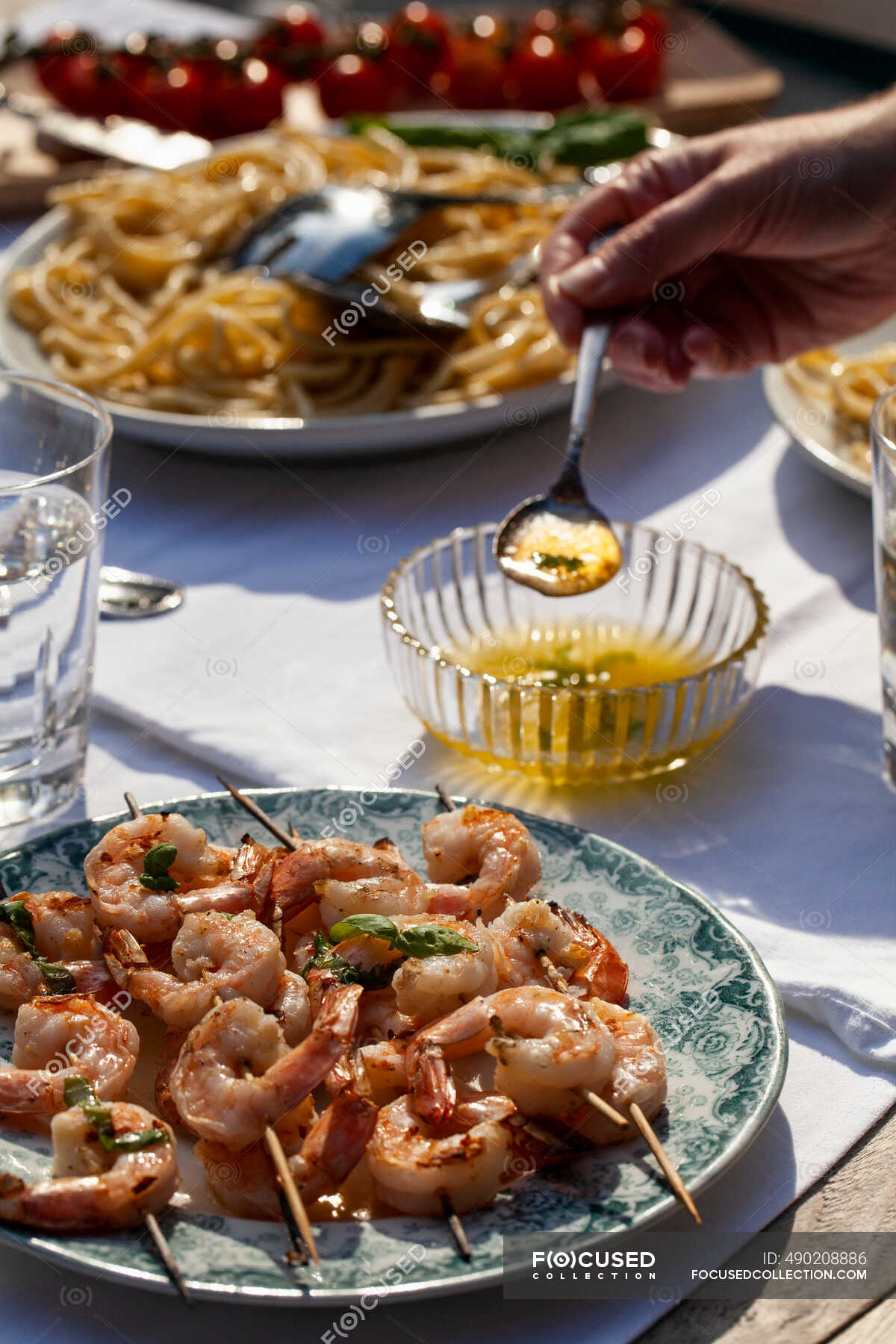 Shrimp skewers with basil butter sauce, pasta cacio e pepe, pasta with