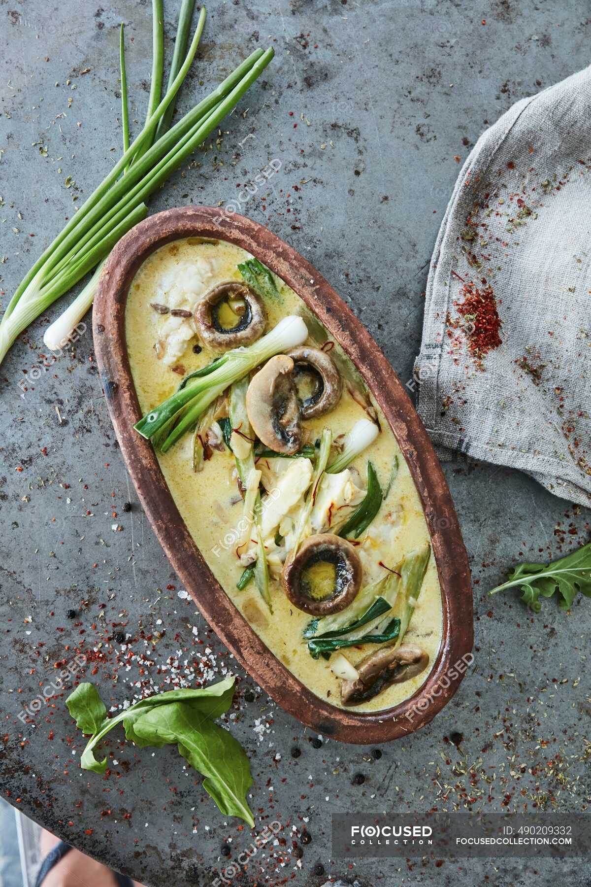 Oven cooked fish fillets with mushrooms and spring onions in cream