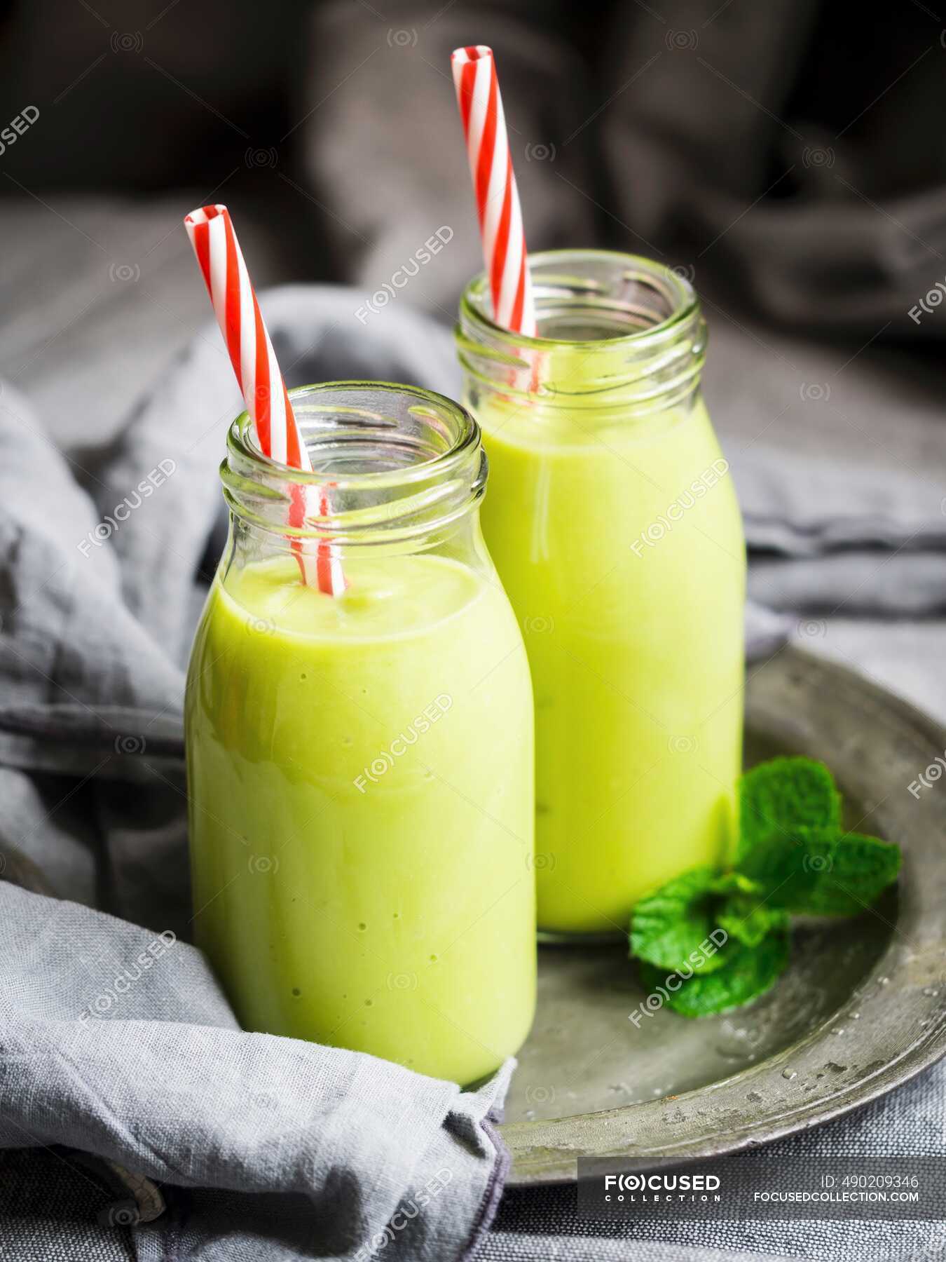 Vegan green smoothies in glass bottles with straws — recipe, fruits - Stock  Photo | #490209346