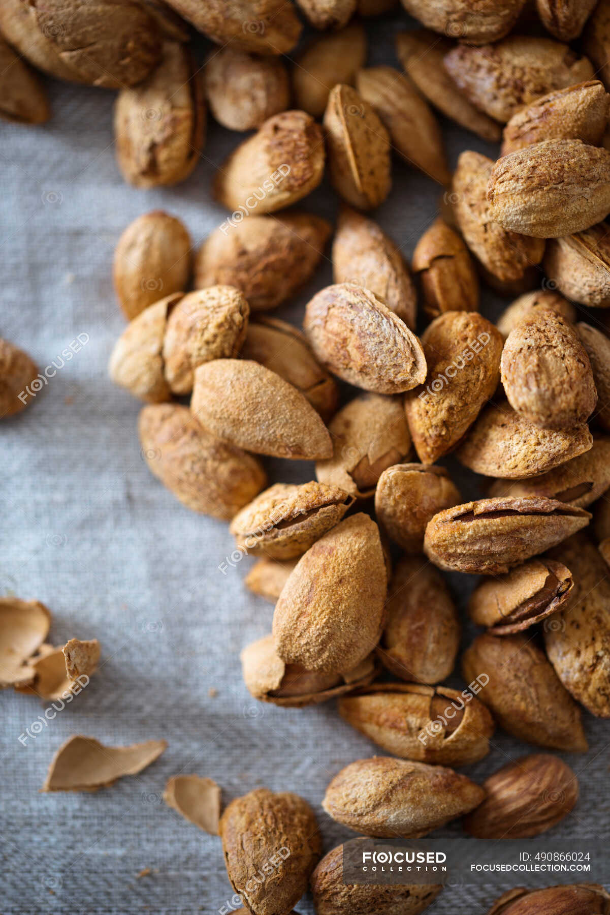 Salted, roasted almonds in shells — selective focus, closeup Stock