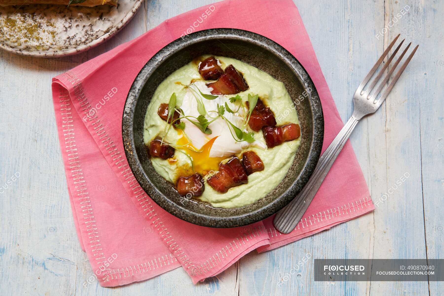 Indian Avocado Lardons with Poached Egg — clean eating, organic Stock Photo 490870940