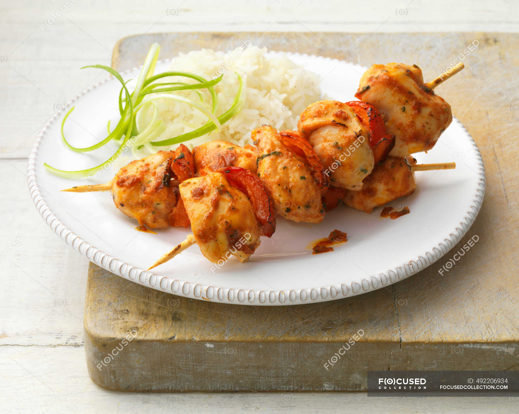 Sweet chilli chicken kebabs — rice, chilies Stock Photo 492206934