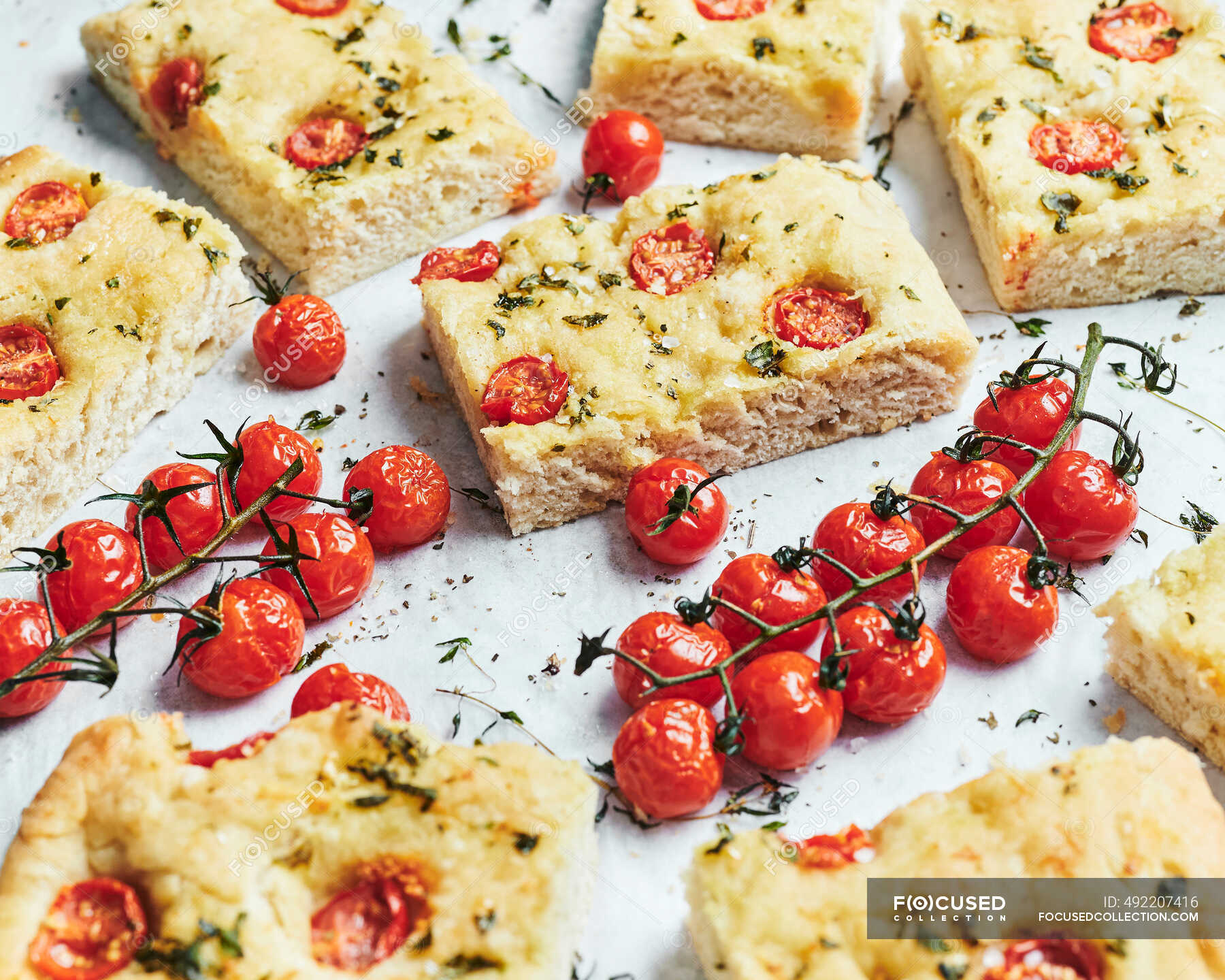 Italian Focaccia with roasted tomatoes on vines — portions ...