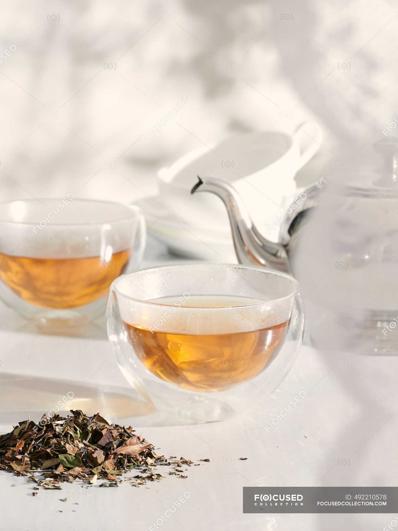 White tea in glass cups — hot, teapot Stock Photo 492210578