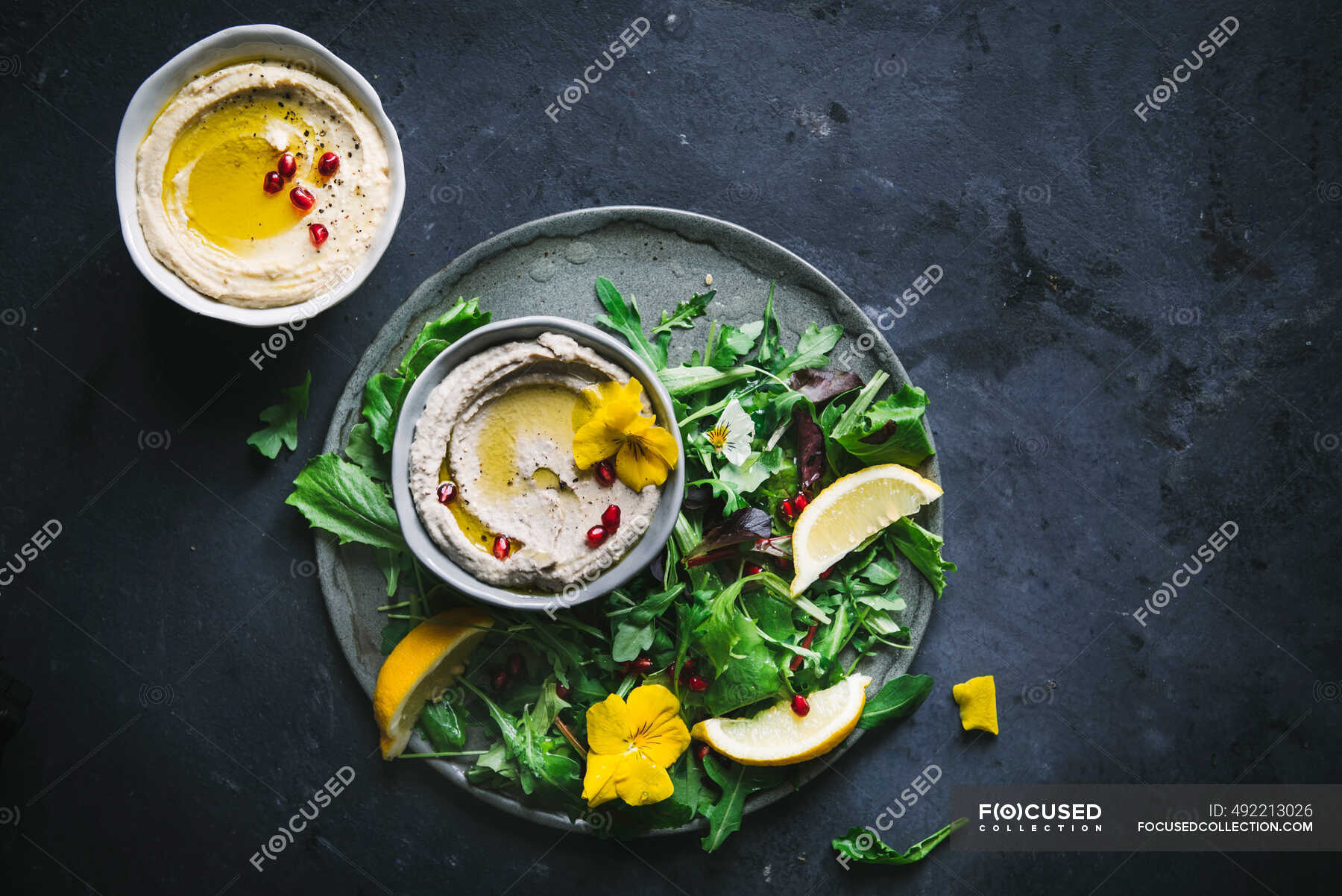 Baba ganoush and Hummus in bowls with green salad — serving, served