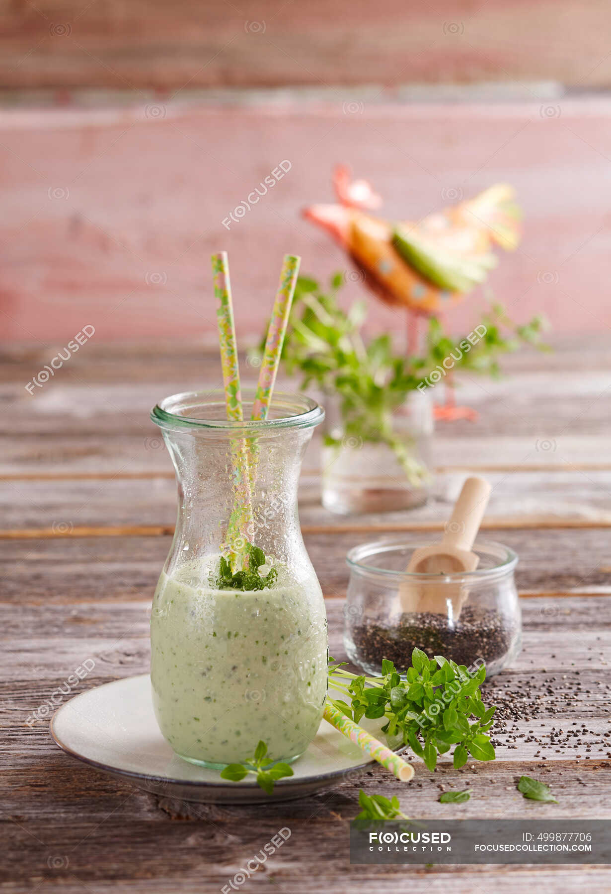 A basil smoothie with chia seeds, yoghurt, banana, milk and lime