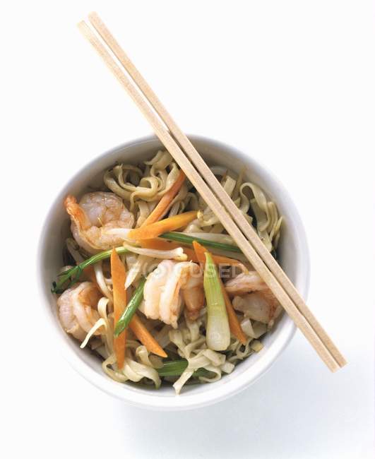 Shrimps and vegetables over noodles — Stock Photo
