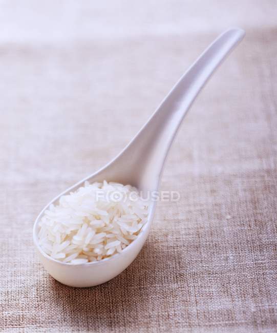 Long-grain rice on spoon — Stock Photo