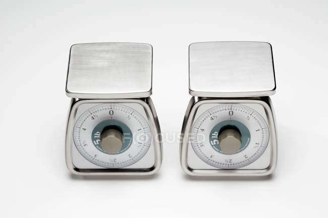 Elevated view of two empty scales on white surface — Stock Photo