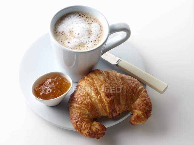 Croissant with marmalade and  cup — Stock Photo