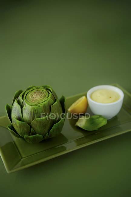 Artichoke with Lemon sauce — Stock Photo