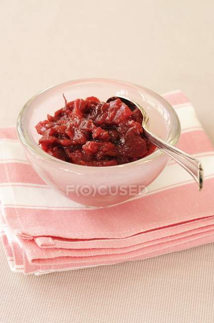 Closeup view of cranberry, apple and orange Chutney in glass bowl — Stock Photo