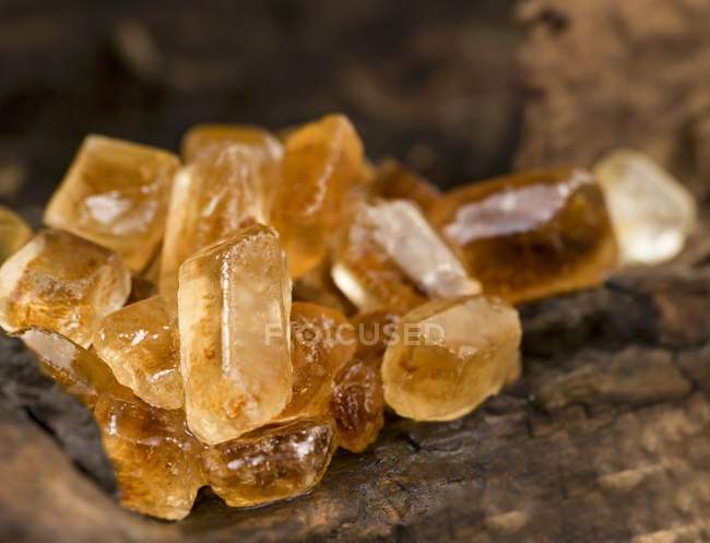 Closeup view of brown candied sugar on a wooden surface — Stock Photo