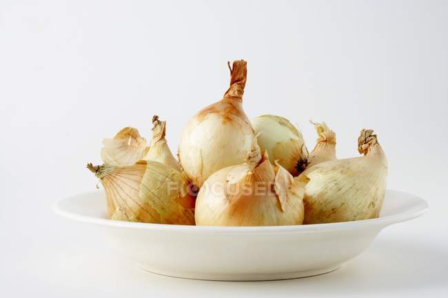 Onions in a deep dish — Stock Photo