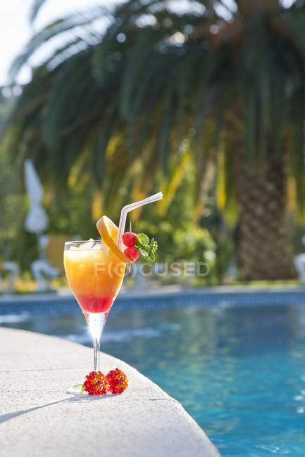 Tequila Sunrise by a pool — Stock Photo