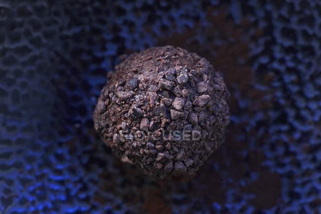 Closeup view of rum truffle with a chocolate crust — Stock Photo