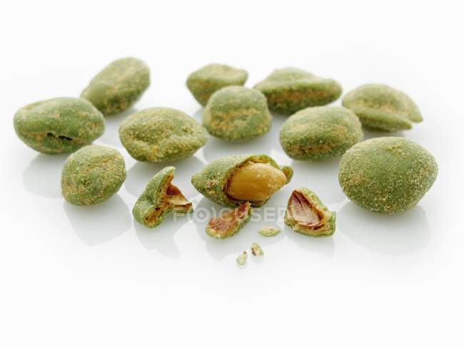 Wasabi peanuts on white surface — Stock Photo