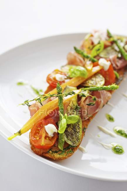 Baguette with ham on plate — Stock Photo