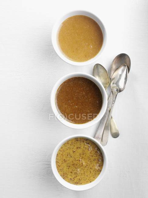Différents types de moutarde dans des bols — Photo de stock