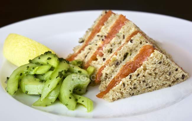Сендвіч з копченим лососем та огірковим салатом — стокове фото