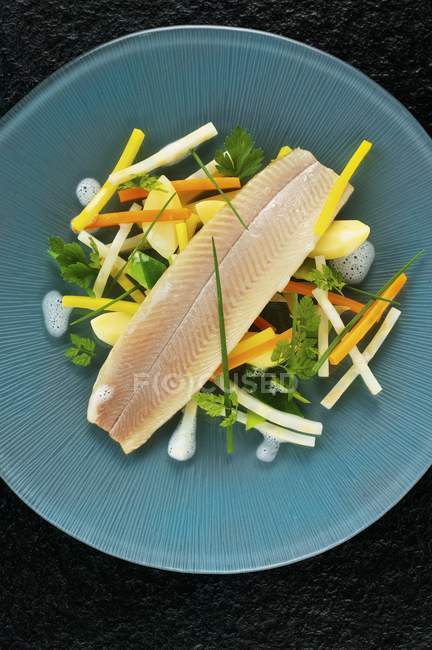 Poached trout fillet with root vegetables — Stock Photo