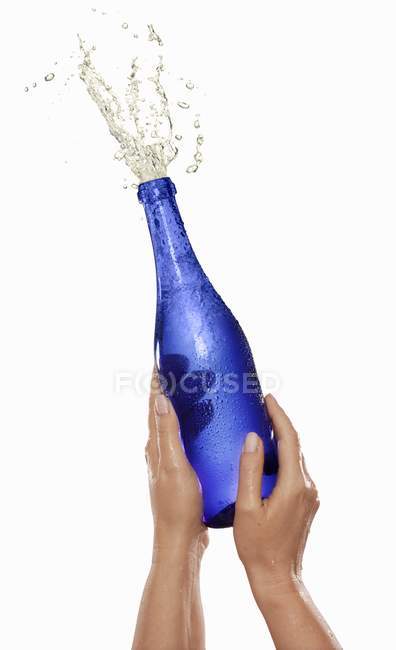 Spraying champagne bottle — Stock Photo