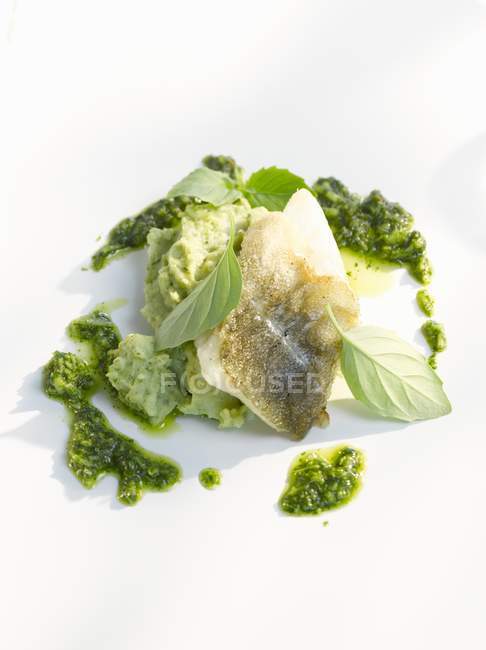 Fish fillet with pesto and pureed basil — Stock Photo