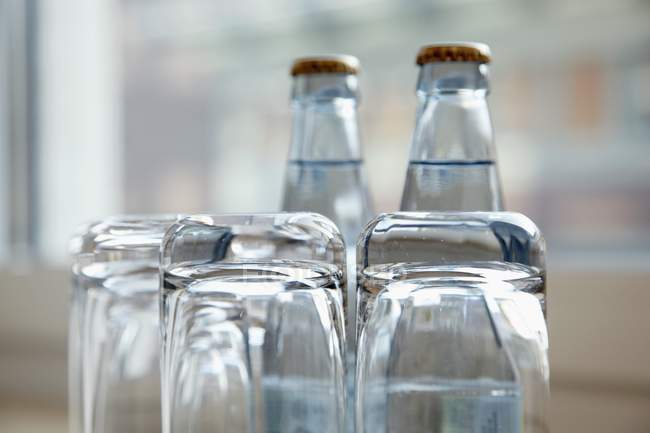 Closeup view of glasses and bottles of water — Stock Photo