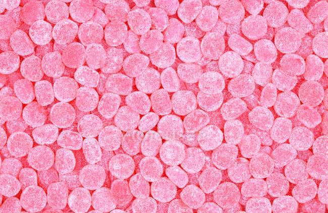 Top view of pink chewy candies background — Stock Photo