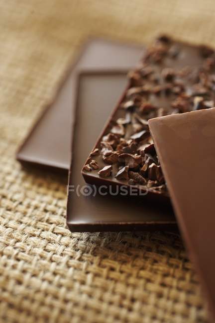 Chocolate bars on table napkin — Stock Photo