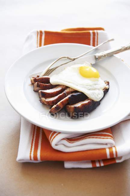 Нарезанная жареная свинина и жареное яйцо — стоковое фото